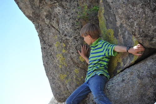 Alex scalling boulder at BoulderCrest Ranch