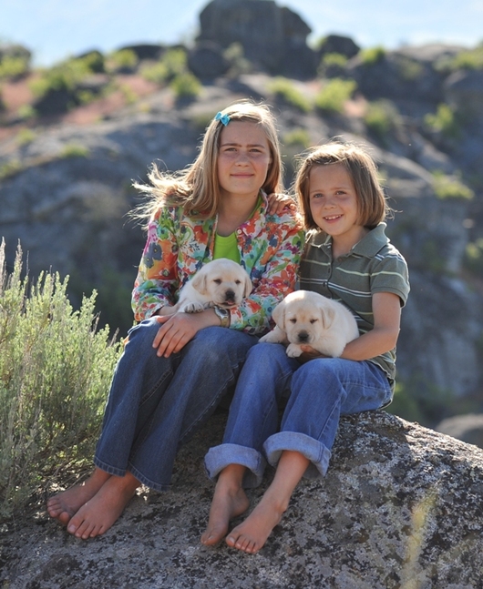 Tori and Calli with two Legacy Labrador puppies at BoulderCrest Ranch